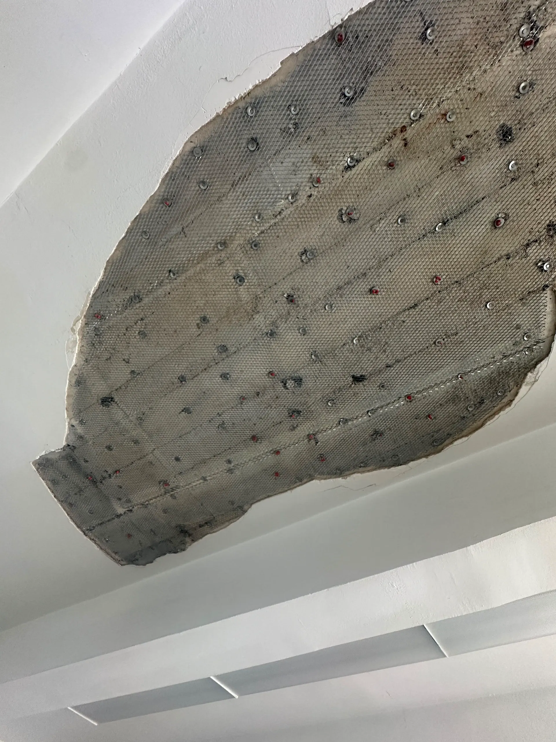 Plaster and lath ceiling repair detail during a verified construction process