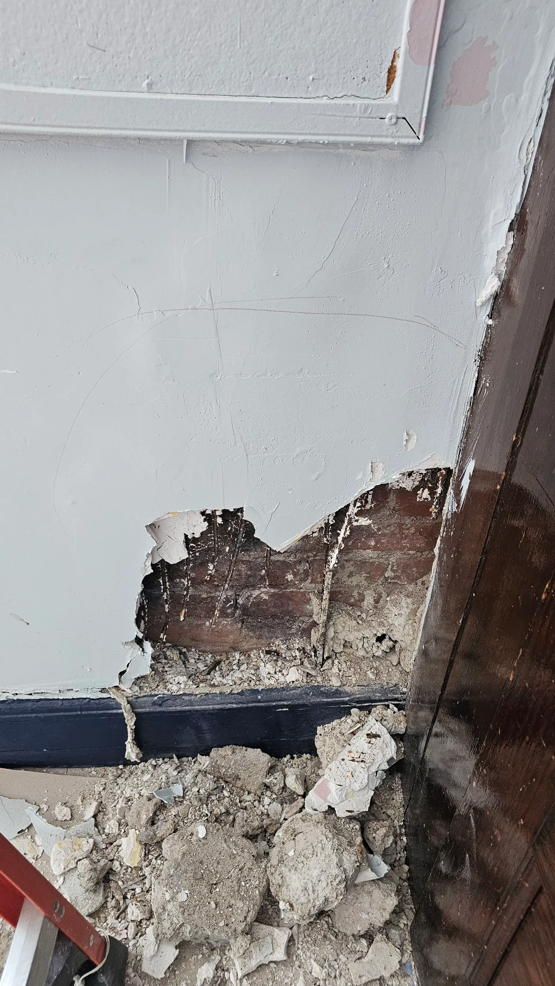 Wall-demolition and structural-assessment detail during verified construction work